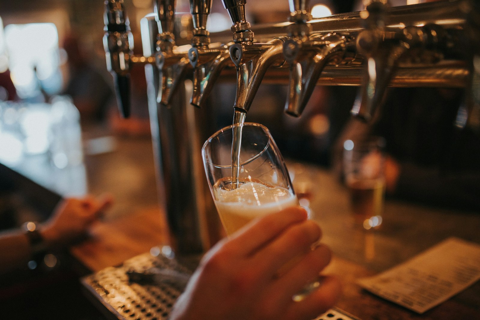 Cold craft beer being poured at the bar