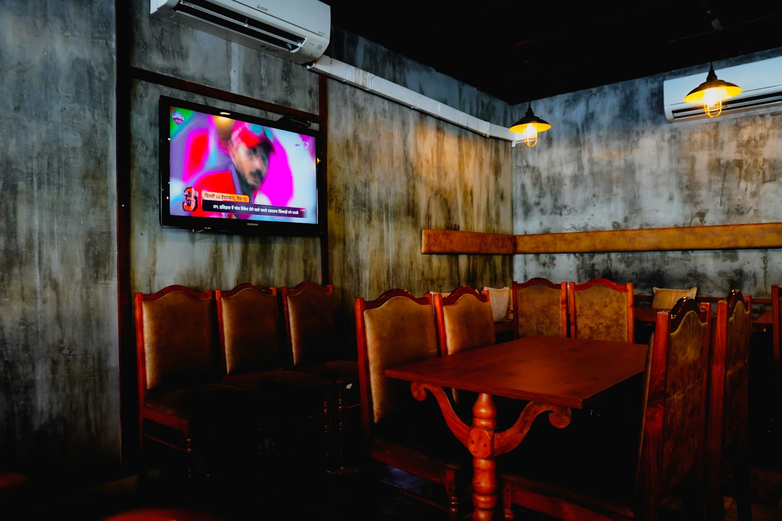 Comfortable booth seating with a wall-mounted TV for watching the game