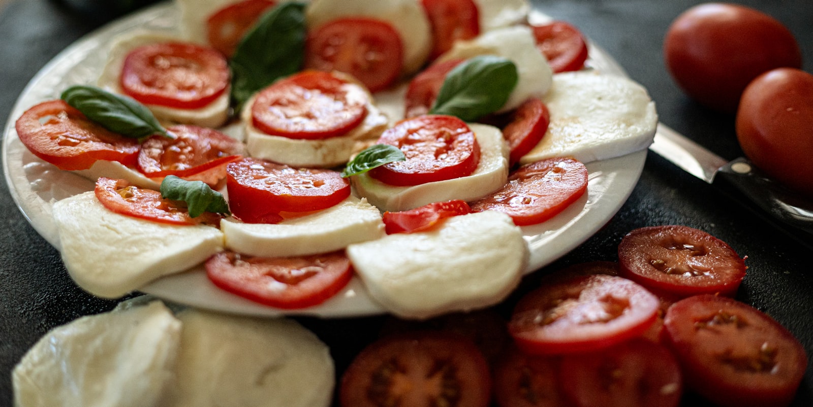 Fresh mozzarella, tomatoes, and basil ingredients for margherita pizza